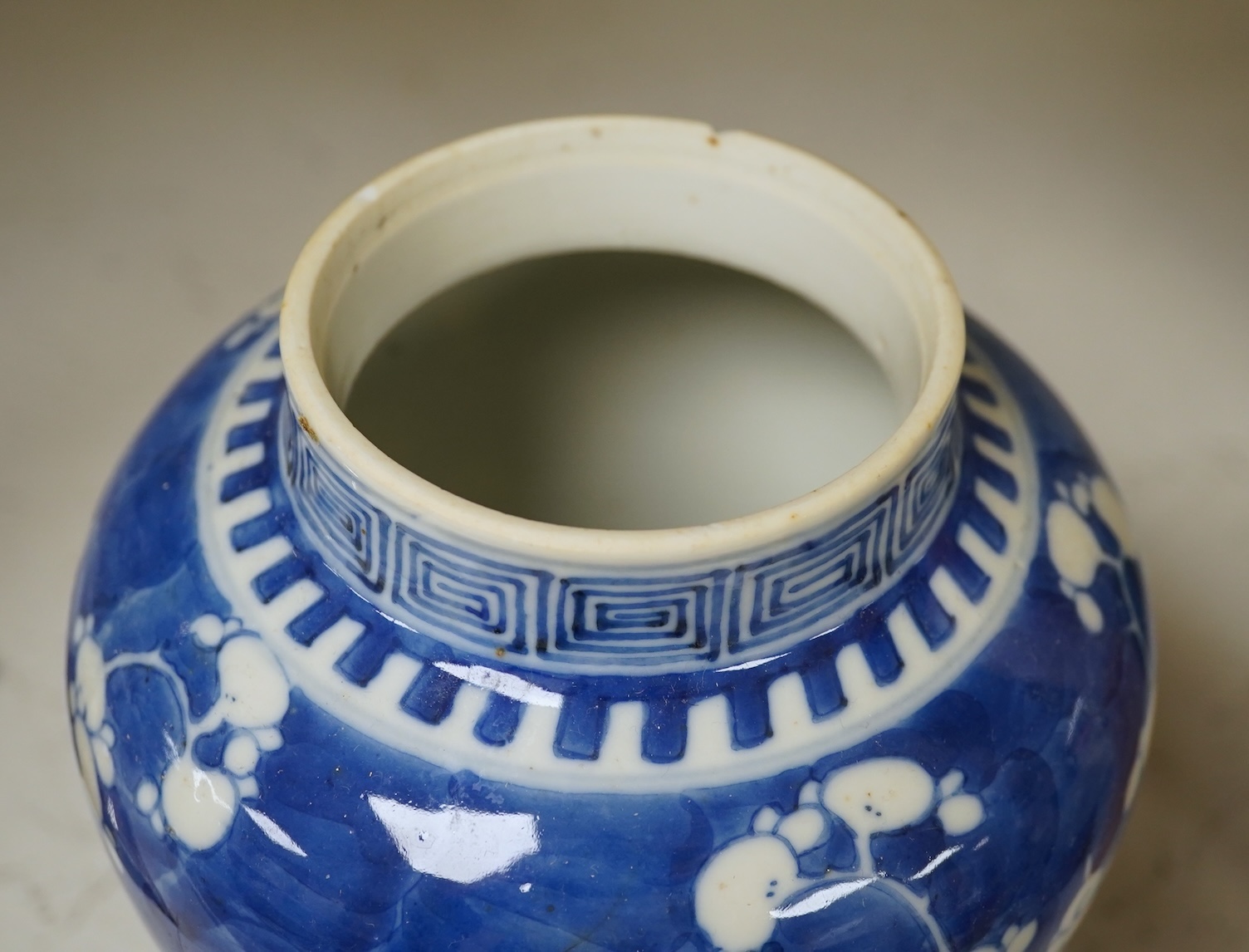 A 19th century Chinese blue and white 'prunus' vase, a Chinese green glazed jar, a Japanese vase and two dishes and two Canton famille rose plates (7). Condition - fair to good